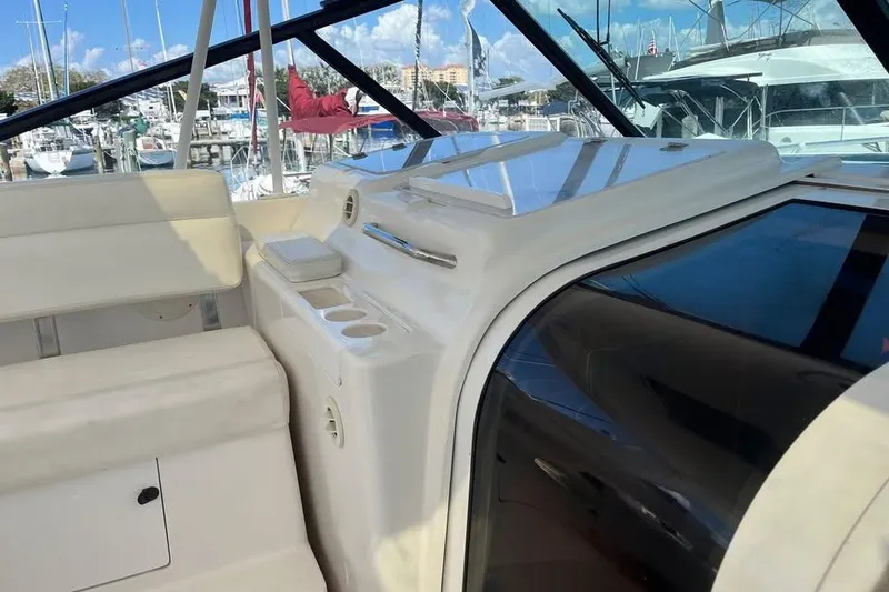 Slide: The Image of 2002 Tiara Yachts 4300 Open interior with seating and marina view. - 4