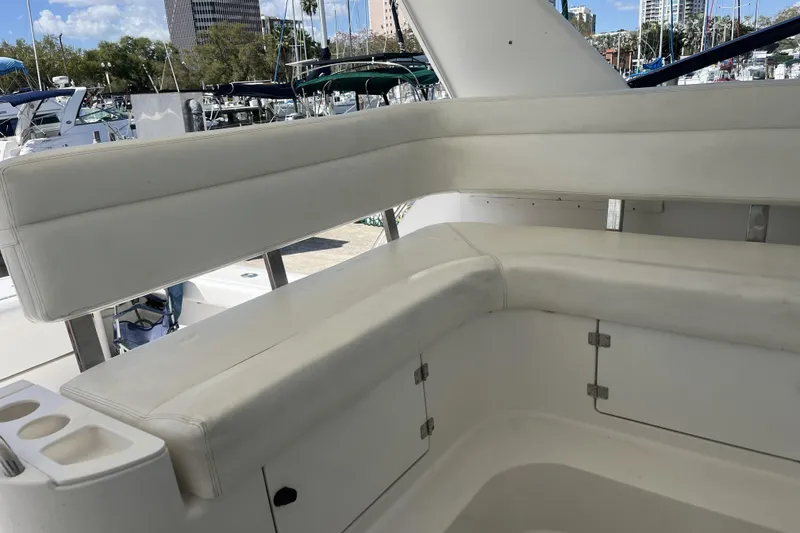 Slide: The Image of 2002 Tiara Yachts 4300 Open boat with white cushioned seating in marina setting. - 6