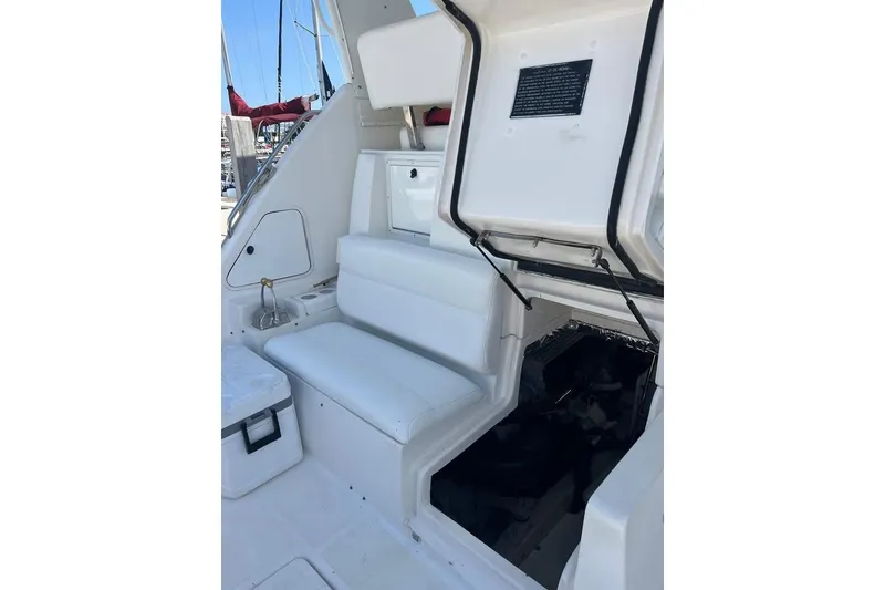Slide: The Image of 2002 Tiara Yachts 4300 Open interior with white seating and open storage compartment. - 7