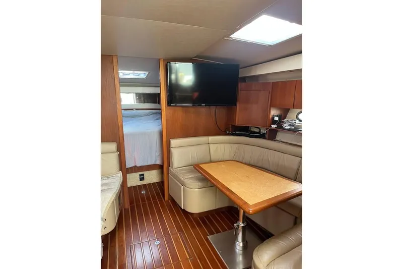 Slide: The Image of Interior of 2002 Tiara Yachts 4300 Open with cozy seating and wooden finishes. - 9