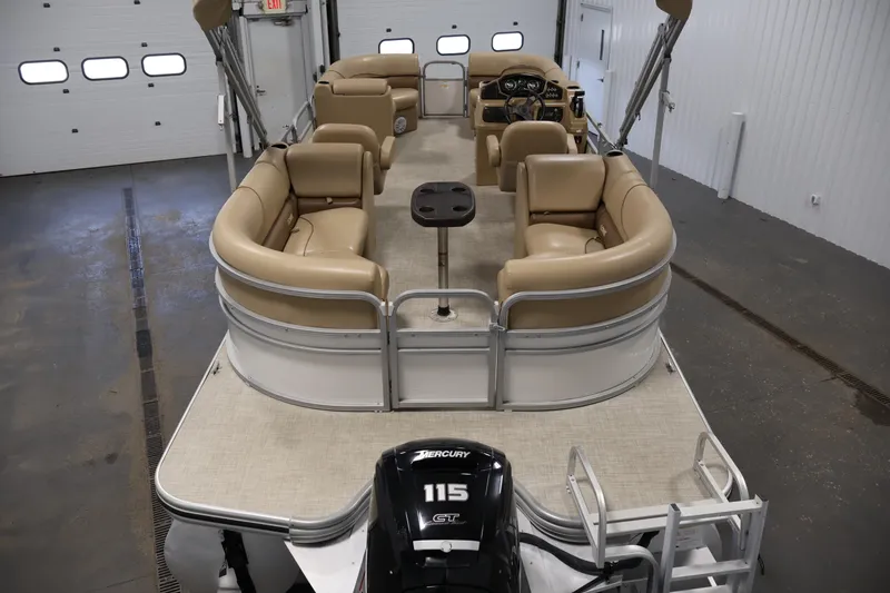 Slide: The Image of 2021 Lowe SS 230 WT pontoon boat with beige seating and Mercury 115 engine in a garage. - 10