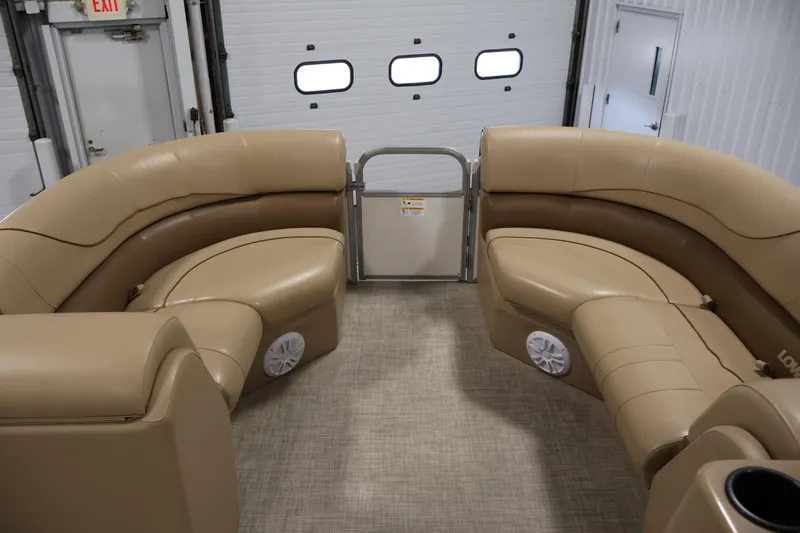 Slide: The Image of 2021 Lowe SS 230 WT boat interior with tan seating and speakers. - 11