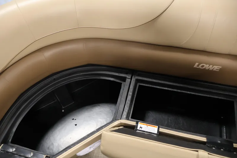 Slide: The Image of 2021 Lowe SS 230 WT boat interior storage compartments with beige seating. - 17