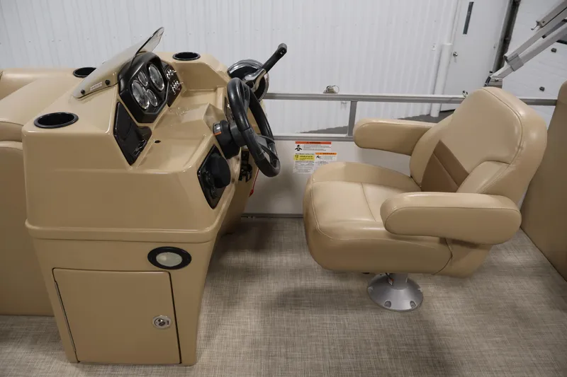 Slide: The Image of 2021 Lowe SS 230 WT boat helm with beige captain's chair and steering console. - 18