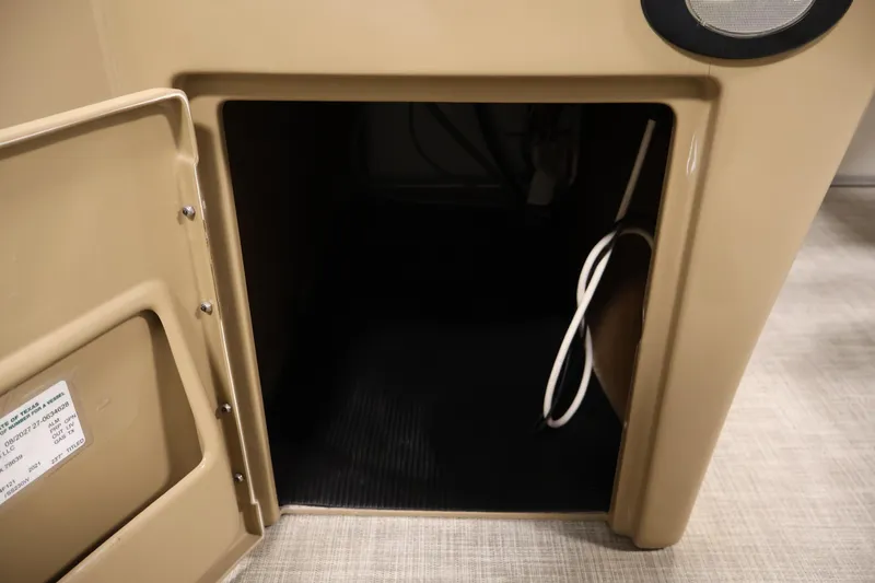 Slide: The Image of Open storage compartment in 2021 Lowe SS 230 WT boat interior. - 19