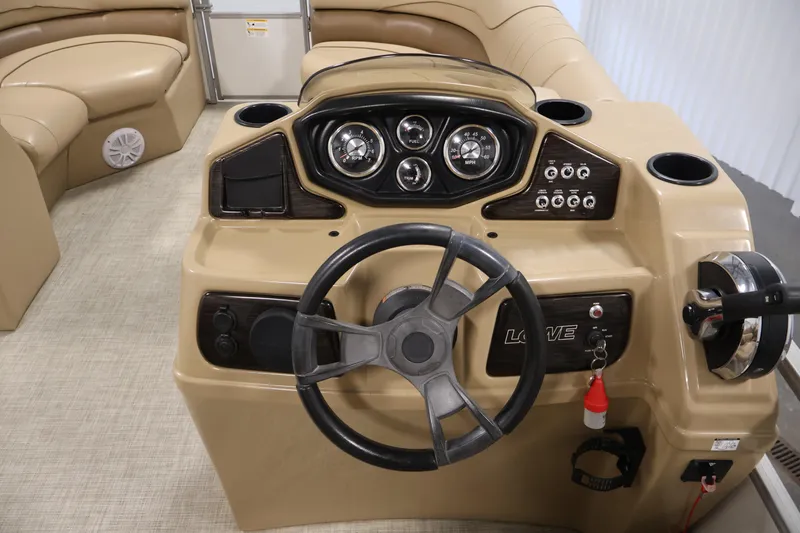 Slide: The Image of Steering console of a 2021 Lowe SS 230 WT pontoon boat with beige interior. - 20
