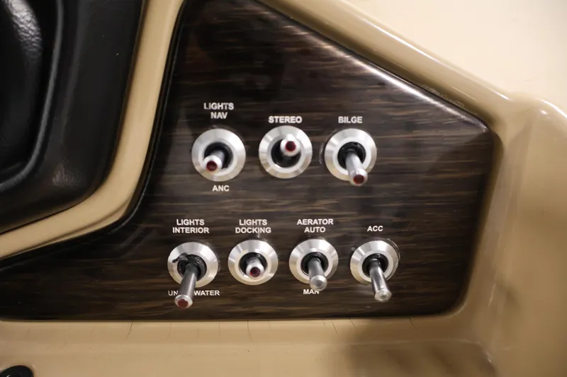 Slide: The Image of Control panel of 2021 Lowe SS 230 WT boat with various switches. - 24