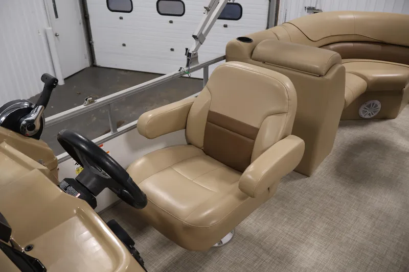 Slide: The Image of 2021 Lowe SS 230 WT boat interior with beige captain's chair and steering console. - 28