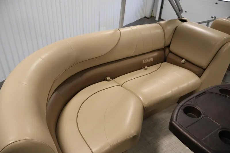 Slide: The Image of 2021 Lowe SS 230 WT boat interior with beige leather seating and cup holders. - 31