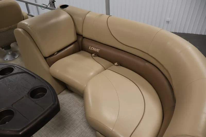 Slide: The Image of 2021 Lowe SS 230 WT boat interior with beige leather seating and cupholder table. - 34