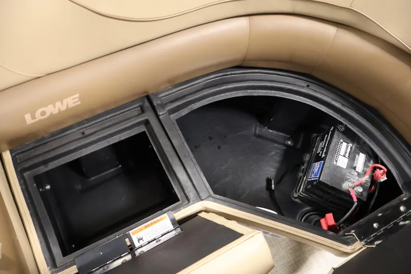 Slide: The Image of Storage compartment and battery in 2021 Lowe SS 230 WT boat interior. - 36