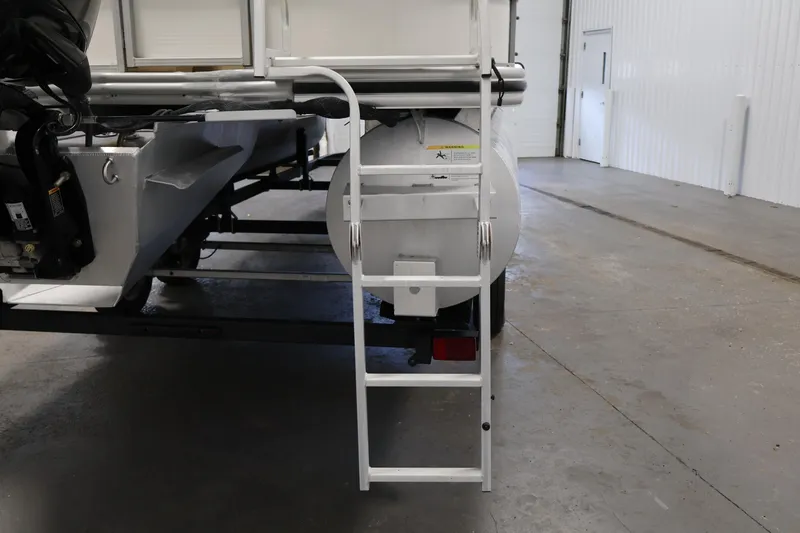 Slide: The Image of Rear view of 2021 Lowe SS 230 WT pontoon boat with ladder in a garage. - 39