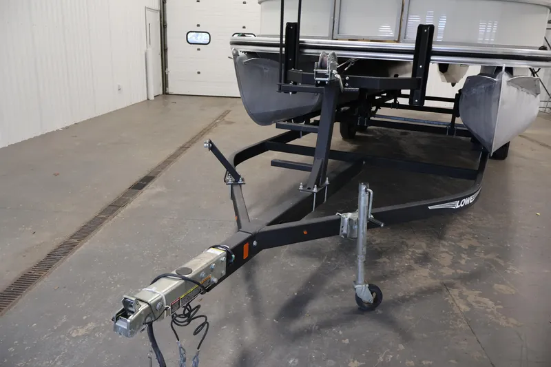 Slide: The Image of 2021 Lowe SS 230 WT pontoon boat on trailer in indoor storage. - 44