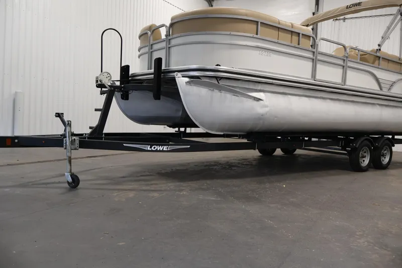 Slide: The Image of 2021 Lowe SS 230 WT pontoon boat on trailer in indoor storage. - 46