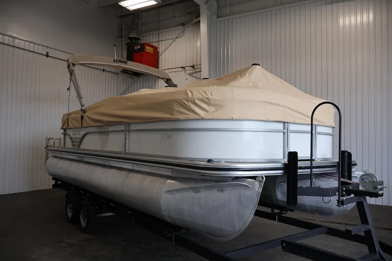 Slide: The Image of 2021 Lowe SS 230 WT pontoon boat with cover in indoor storage. - 48