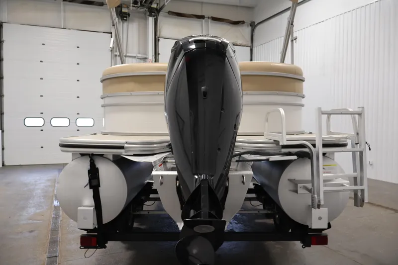 Slide: The Image of 2021 Lowe SS 230 WT pontoon boat in a garage, rear view. - 6