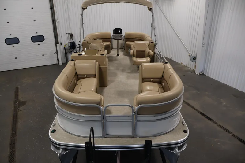 Slide: The Image of 2021 Lowe SS 230 WT pontoon boat with beige seating in a garage. - 9