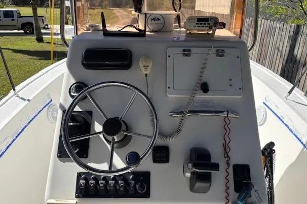 Slide: The Image of Console of a 2006 Clearwater 2100 boat with steering wheel and controls. - 10