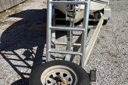 Slide: The Image of Trailer with spare tire for 2006 Clearwater 2100 boat on gravel surface. - 11