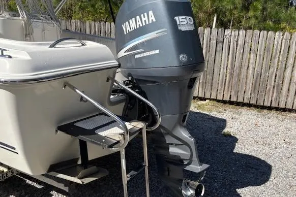 Slide: The Image of 2006 Clearwater 2100 boat with Yamaha 150 outboard motor, parked on gravel. - 4