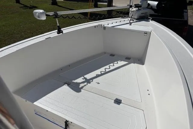 Slide: The Image of 2006 Clearwater 2100 boat interior with trolling motor, showcasing spacious deck and storage. - 6