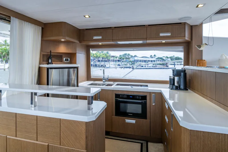 Slide: The Image of Luxurious kitchen interior of 2020 Galeon 550 Fly yacht with modern appliances and waterfront view. - 11