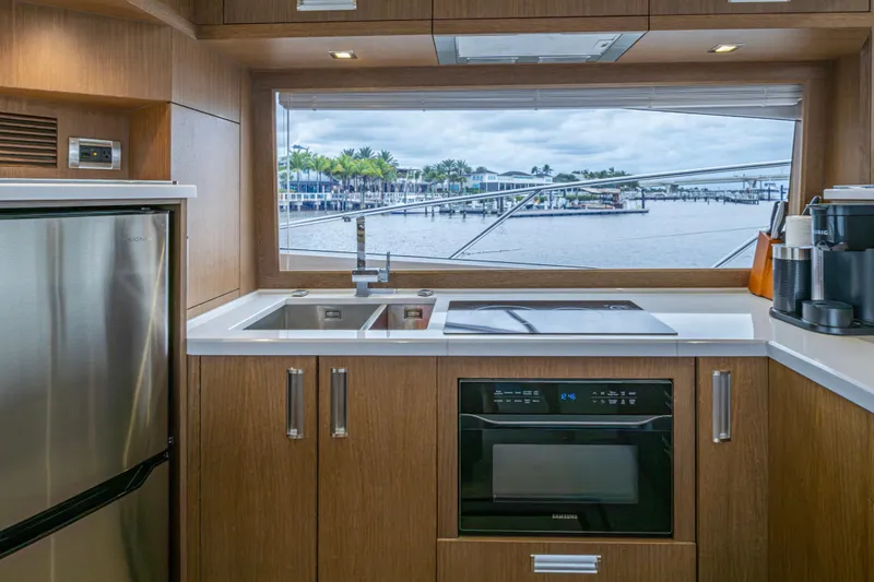 Slide: The Image of Modern kitchen interior of 2020 Galeon 550 Fly yacht with waterfront view. - 12