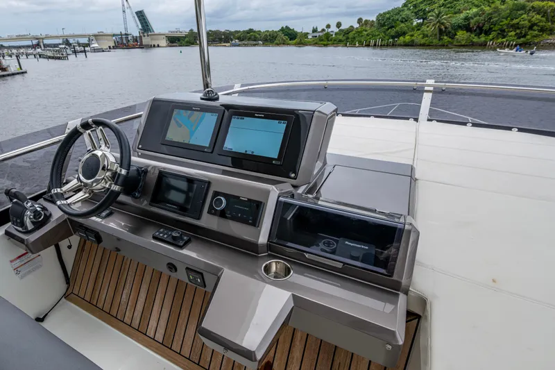 Slide: The Image of Helm of 2020 Galeon 550 Fly yacht with navigation screens and steering wheel. - 14