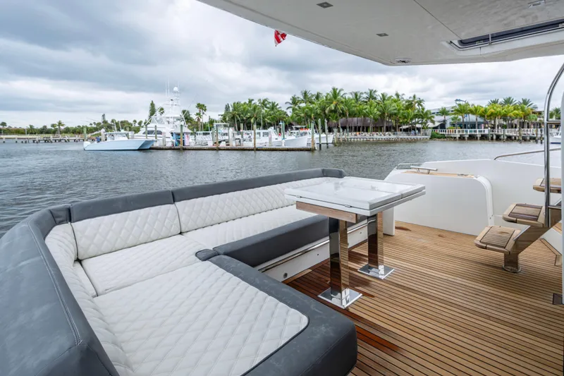 Slide: The Image of Luxurious 2020 Galeon 550 Fly yacht deck with elegant seating and scenic waterfront view. - 21
