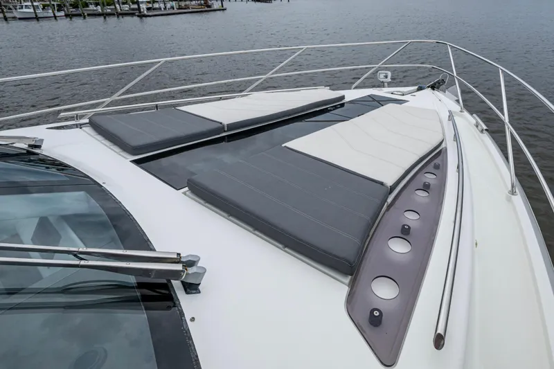 Slide: The Image of 2020 Galeon 550 Fly yacht with sun loungers on deck, overlooking water. - 23