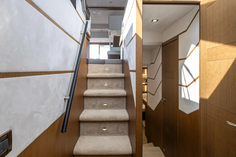 Slide: The Image of Staircase interior of 2020 Galeon 550 Fly yacht, featuring modern design and wood accents. - 28