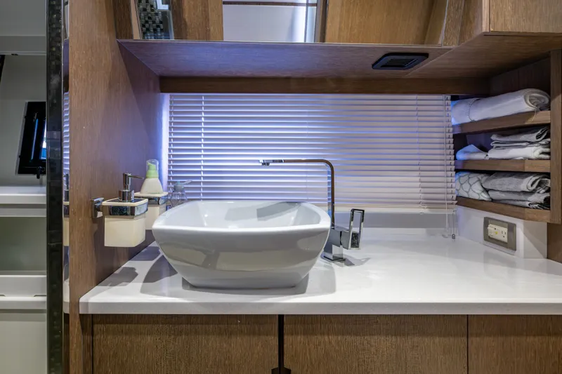 Slide: The Image of Luxury bathroom interior on 2020 Galeon 550 Fly yacht, featuring modern sink and wooden cabinetry. - 33