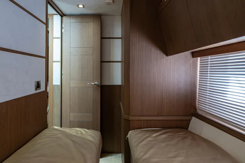 Slide: The Image of Interior of 2020 Galeon 550 Fly yacht cabin with twin beds and wooden decor. - 34
