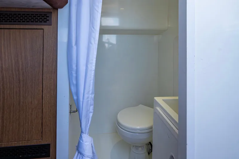 Slide: The Image of Bathroom interior of 2020 Galeon 550 Fly yacht with white curtain and wooden cabinet. - 39