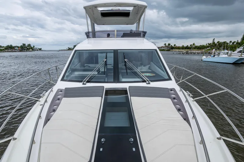 Slide: The Image of 2020 Galeon 550 Fly yacht on water, showcasing sleek design and spacious deck. - 48