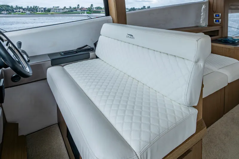 Slide: The Image of Luxurious interior seating of 2020 Galeon 550 Fly yacht with quilted white upholstery. - 5