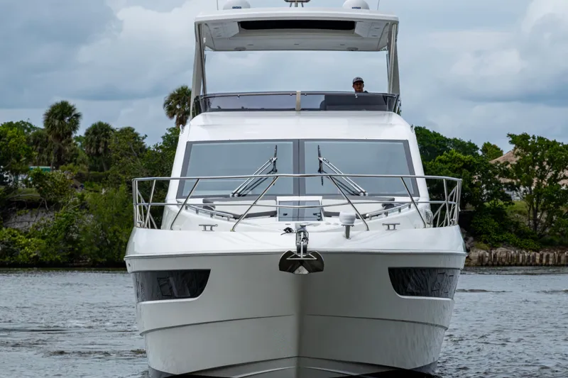 Slide: The Image of 2020 Galeon 550 Fly yacht on water, front view with lush greenery background. - 51