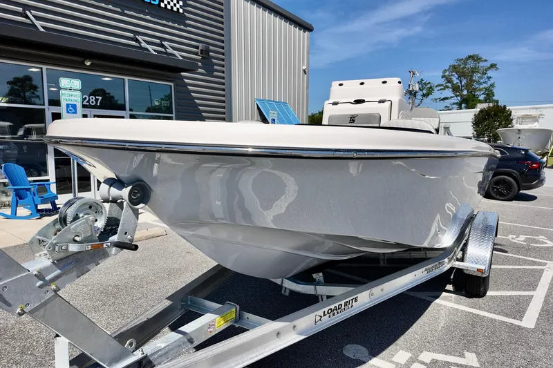 Slide: The Image of 2026 Carolina Skiff 21 Ultra Elite boat on trailer outside dealership. - 5