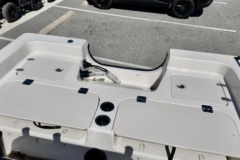 Slide: The Image of 2026 Carolina Skiff 21 Ultra Elite boat deck with storage compartments and cup holders. - 6