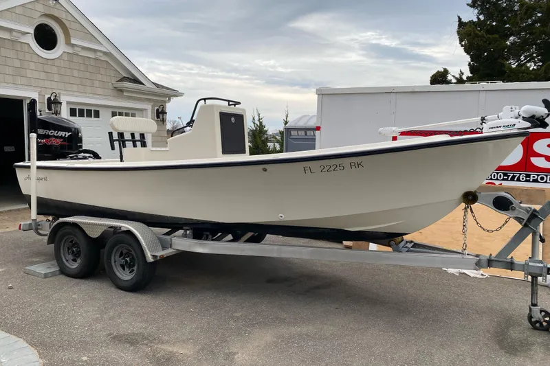 Slide: The Image of 1973 Aquasport 190 Osprey boat on trailer, parked outside a garage. - 4