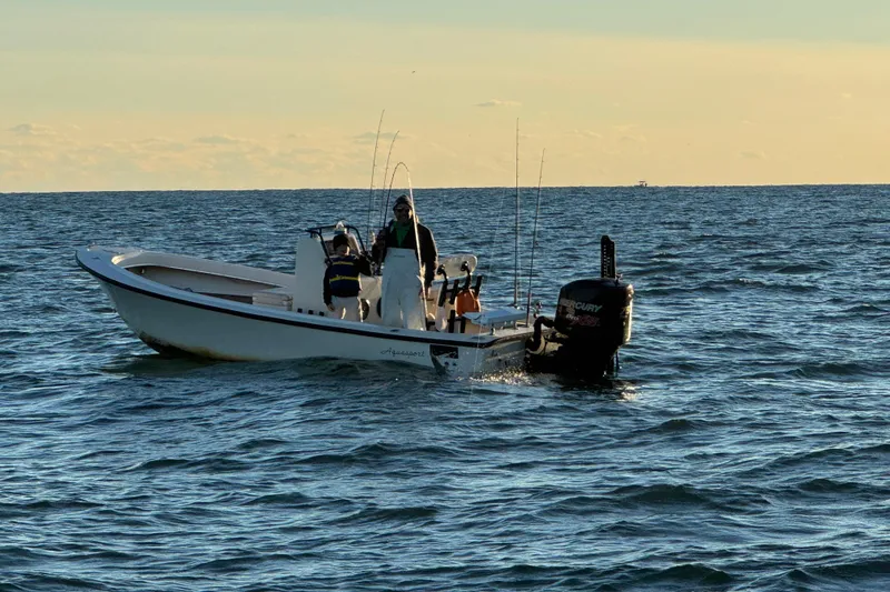 Slide: The Image of 1973 Aquasport 190 Osprey boat on open water, equipped for fishing. - 6