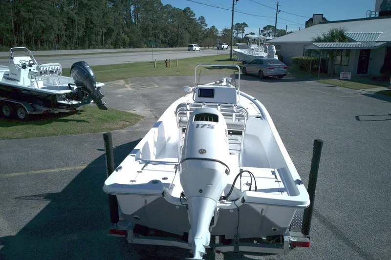 Slide: The Image of 2022 Blazer Bay 2200 boat with outboard motor on trailer in parking lot. - 3