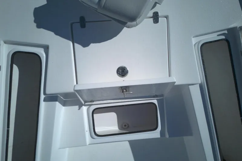 Slide: The Image of 2022 Blazer Bay 2200 boat interior storage compartments and hatch detail. - 6