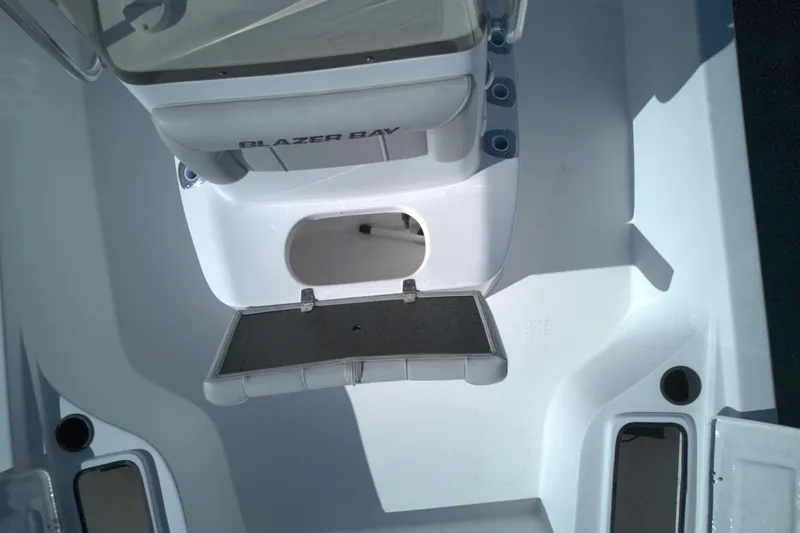 Slide: The Image of 2022 Blazer Bay 2200 boat interior with storage compartment open. - 7
