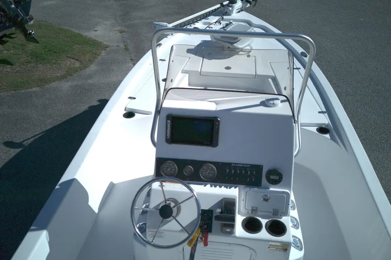 Slide: The Image of 2022 Blazer Bay 2200 boat console with steering wheel and navigation equipment. - 8