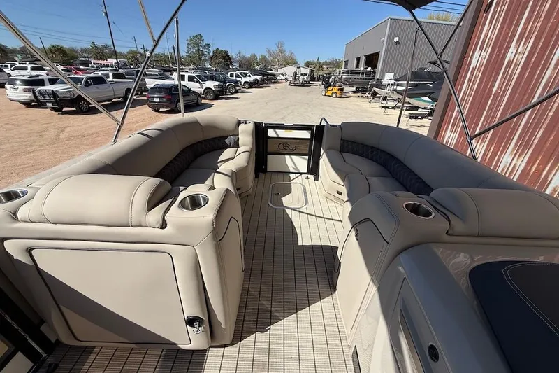 Slide: The Image of 2022 Barletta L23UCA pontoon boat interior with beige seating and cup holders. - 11
