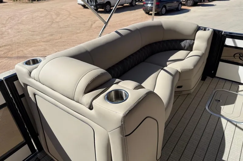 Slide: The Image of 2022 Barletta L23UCA boat interior with beige seating and cup holders. - 12