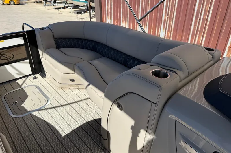 Slide: The Image of 2022 Barletta L23UCA boat interior with plush seating and cup holders. - 13