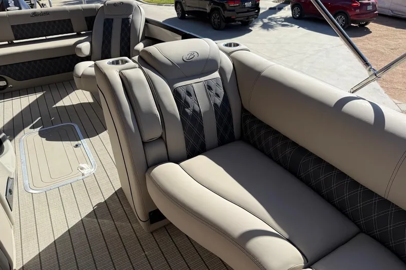 Slide: The Image of Luxurious seating on 2022 Barletta L23UCA pontoon boat with elegant upholstery and cup holders. - 15