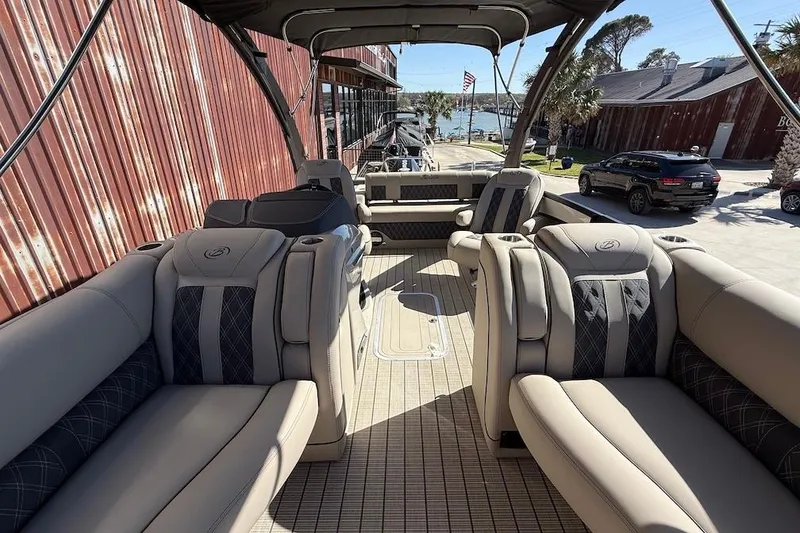 Slide: The Image of 2022 Barletta L23UCA pontoon boat with luxurious seating and waterfront view. - 16